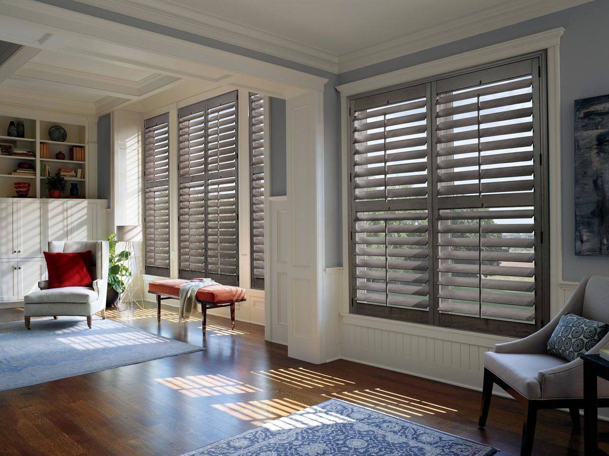 Gray stained Hunter Douglas Heritance® Hardwood Shutters hanging in a hallway near Alpharetta, GA