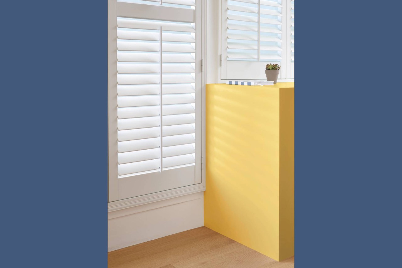 Hunter Douglas Palm Beach™ Polysatin™ Vinyl Shutters with yellow cabinetry near Alpharetta, Georgia (GA)